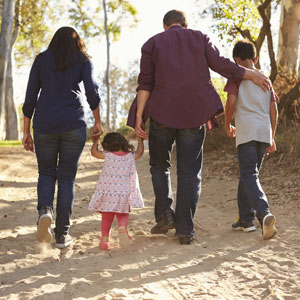 Family walking on rural path representing strong bounding between them - The Law Offices of Timothy Connors.